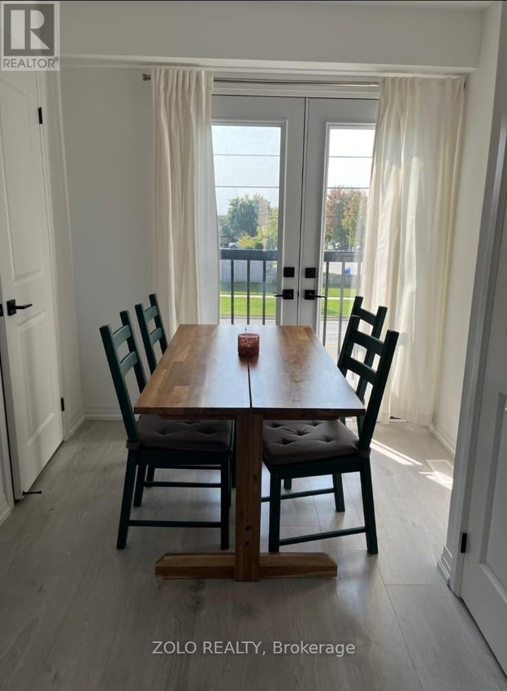 A dining room with a wooden table and chairs.