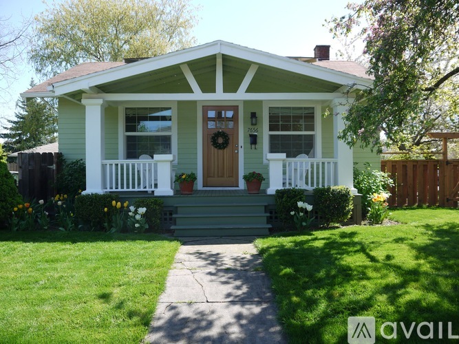 A house with a green front yard and a brown door.