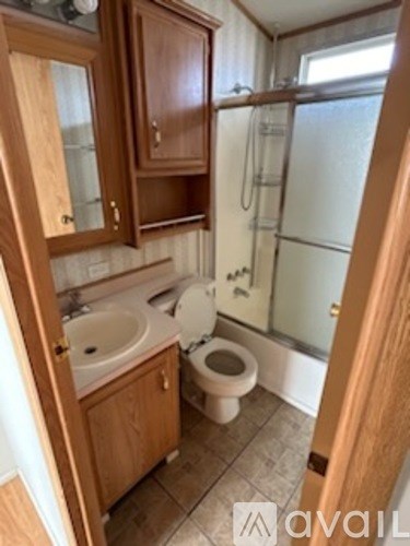 A bathroom with a toilet, sink, and shower.