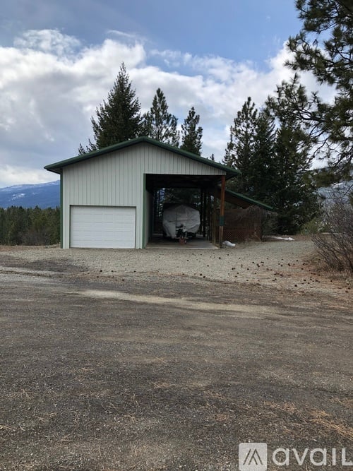 A large garage door is open, revealing a spacious interior.