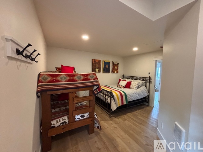 A bedroom with a bed and a bench.