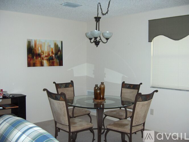 A dining room with a glass table and chairs.