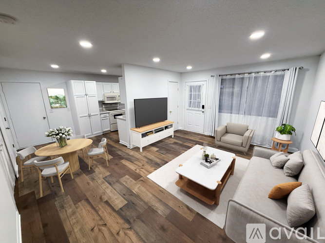 A modern living room with a wooden floor and furniture.
