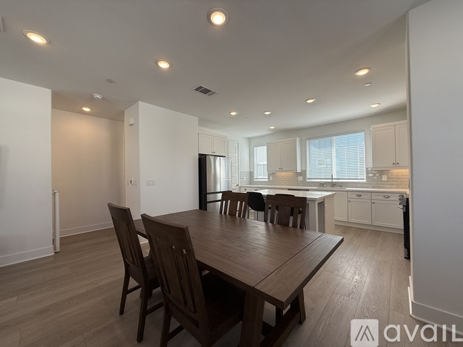 A dining room with a wooden table and chairs.