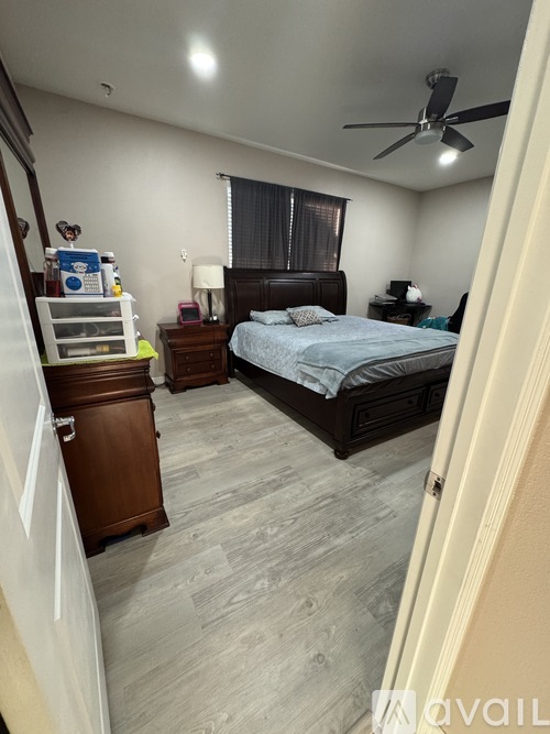 A bedroom with a bed, nightstand, and dresser.