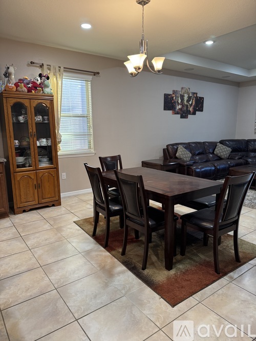 A dining room with a table set for four.