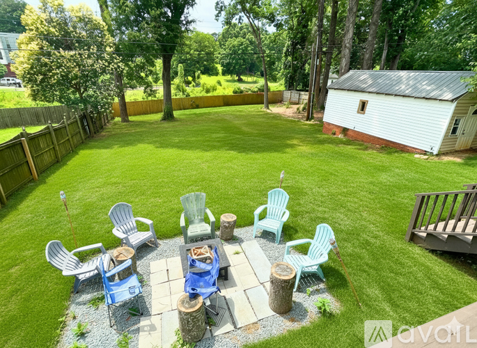 A backyard with a table and chairs set up for an outdoor meal.