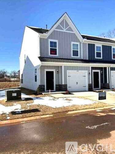 A two-story house with a garage on the ground floor.