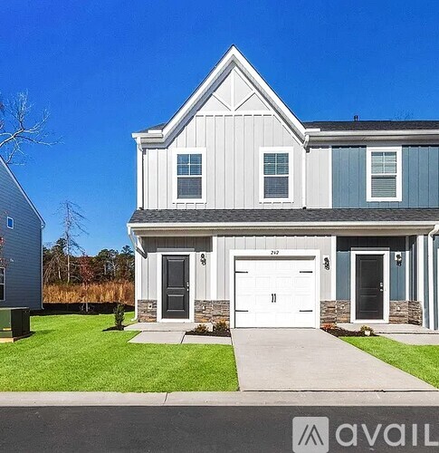 A two-story house with a garage is for sale.