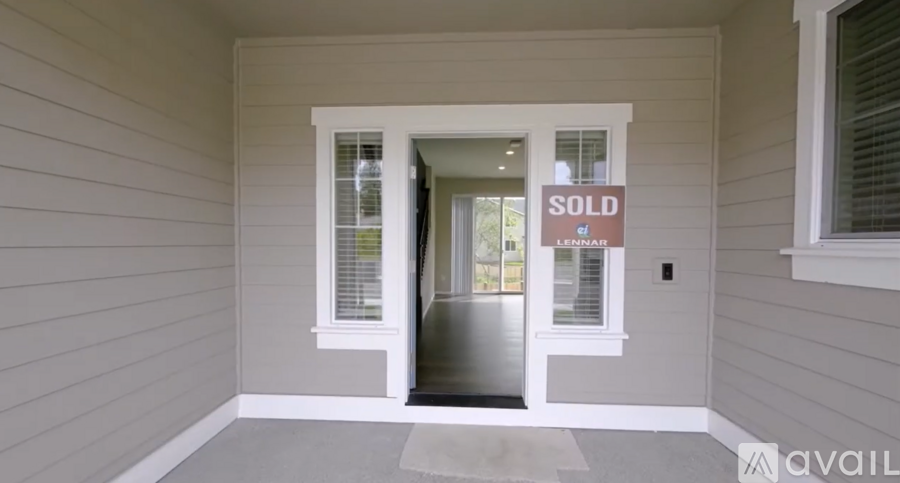 A house entrance with a sold sign.
