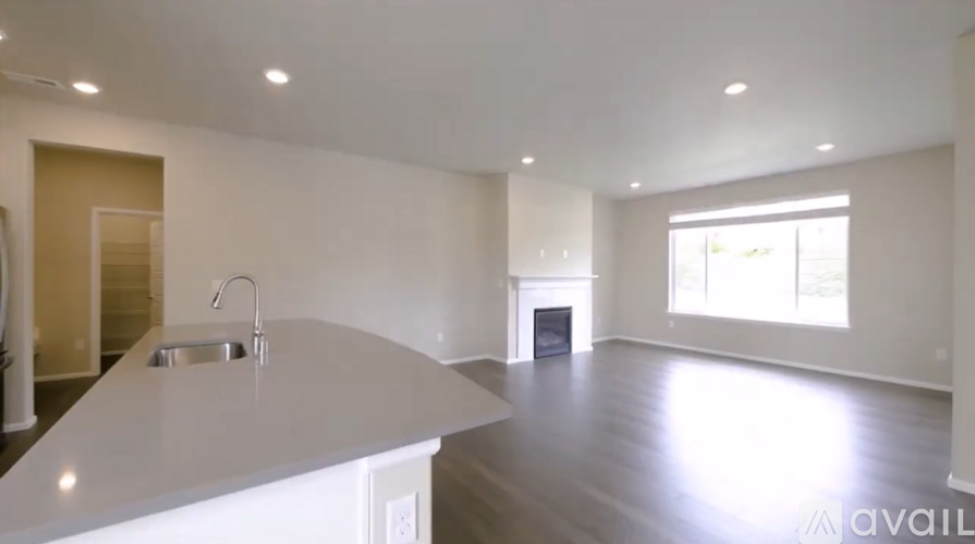 A modern kitchen with a white countertop and a sink.