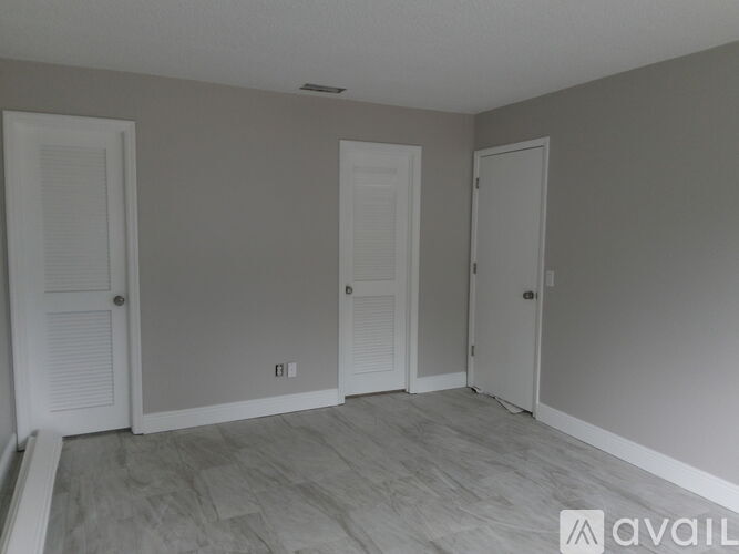 A room with two doors and a window.