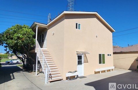 A house with a white door and windows is available for rent.