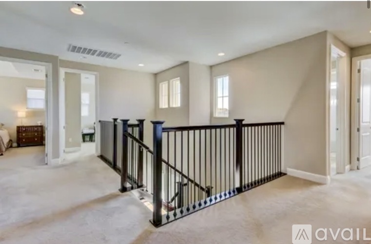A spacious room with a black railing and a sign that says "The Breakers".