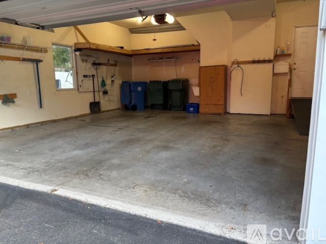 A garage with a concrete floor and a door on the right side.