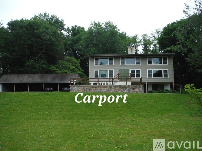 A house with the word Carport written on the grass in front of it.