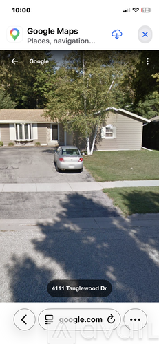 A car is parked in front of a house on 4111 Tanglewood Dr.