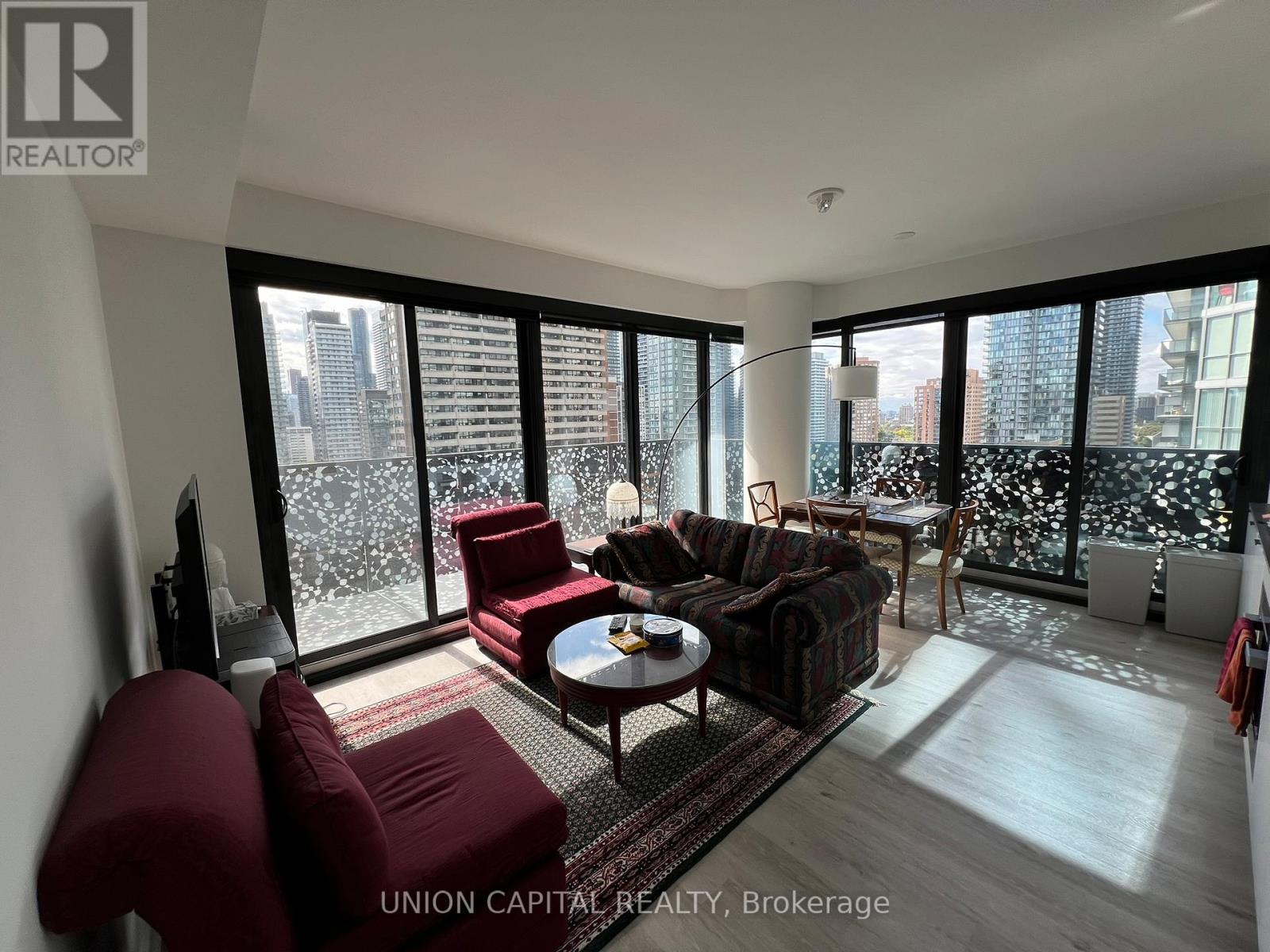 A living room with a view of the cityscape outside the large windows.