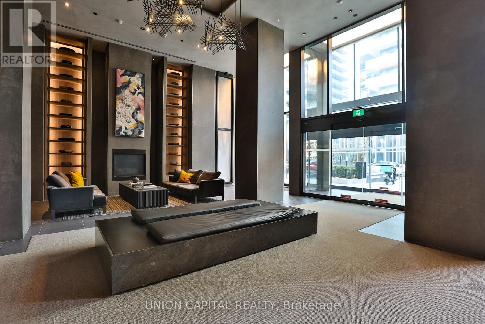 A living room with a red couch and a round table.