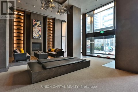 A living room with a red couch and a round table.
