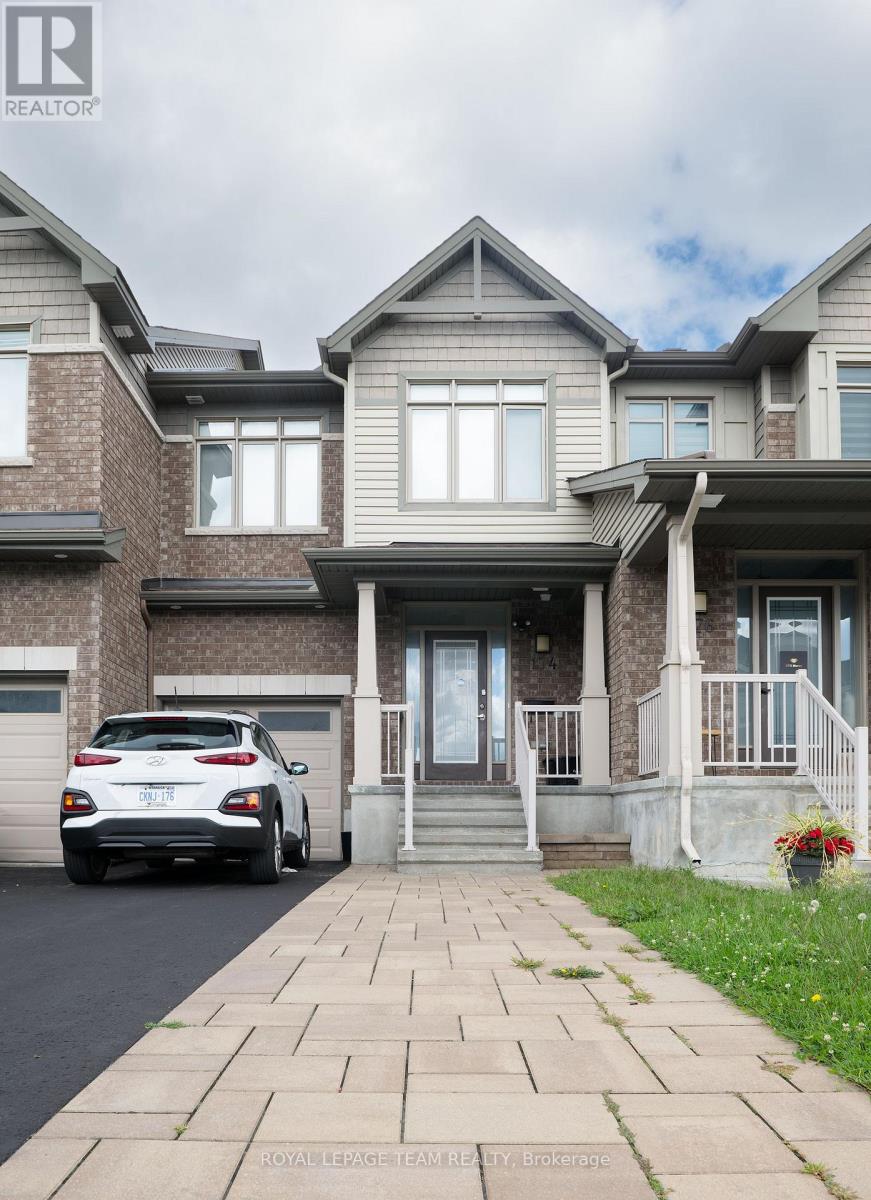 A white car is parked in front of a house.