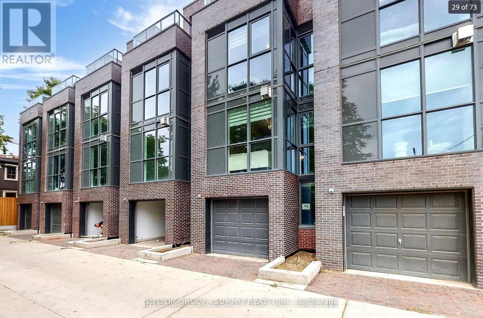 A building with a sign that says REALTOR in the top left corner.