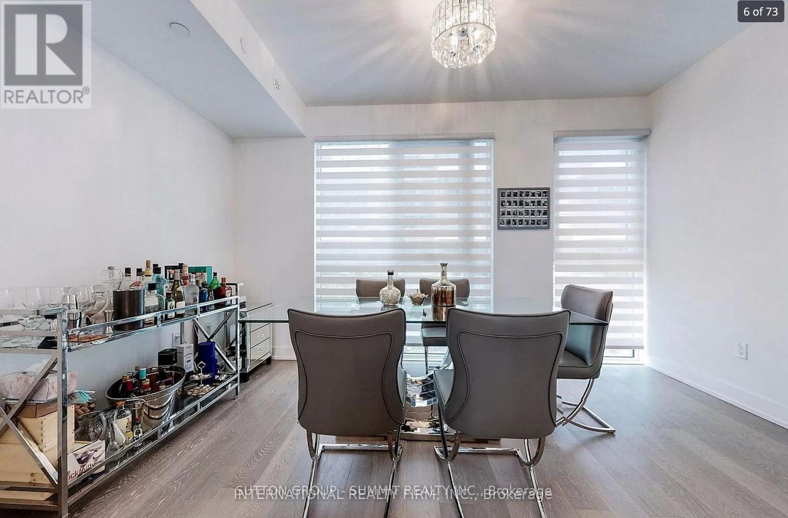 A dining room with a table set for two and a wine rack.
