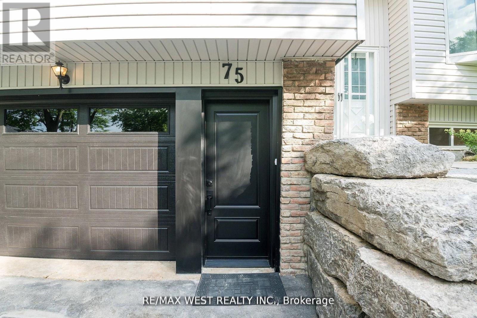 A black door with a glass window is on the left side of the house.
