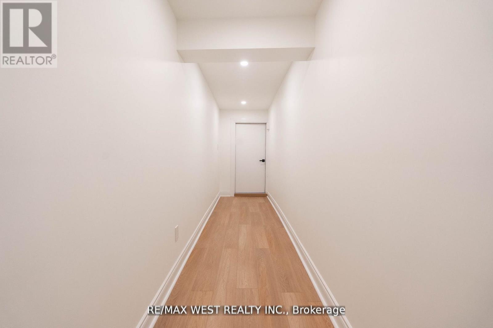 A long hallway with a door at the end.