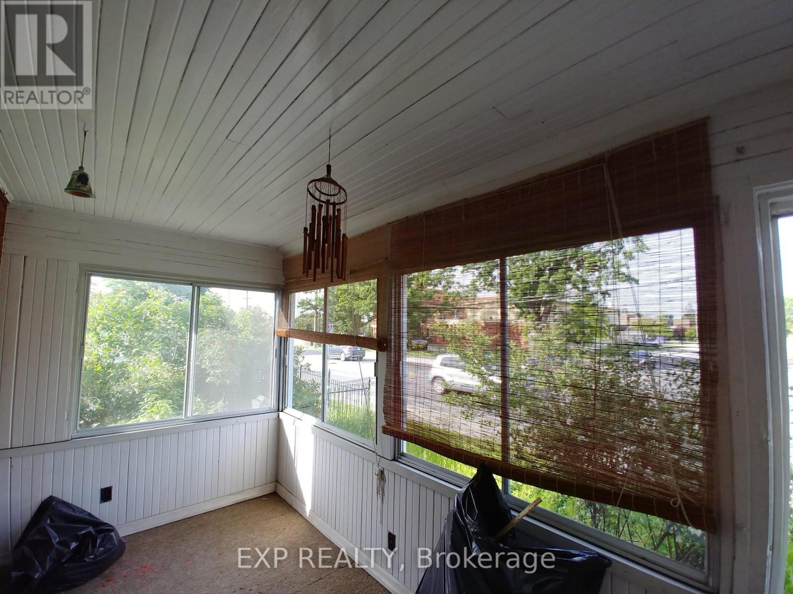 A room with a window covered in a brown mesh.