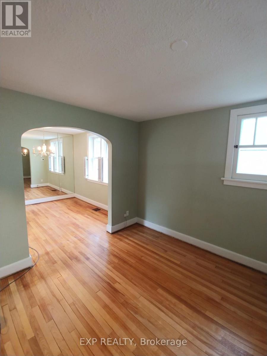 A room with wooden floors and a window.