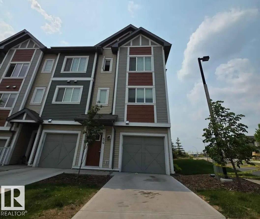 A modern two-story house with a garage and a driveway.