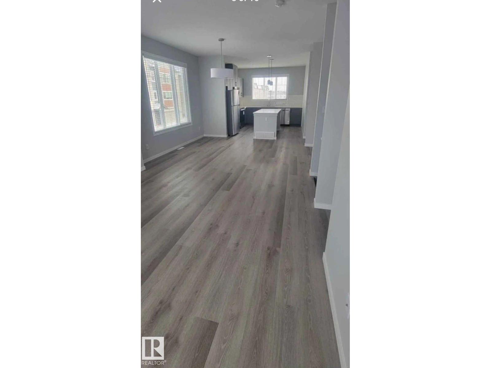 A room with a wooden floor and white walls.