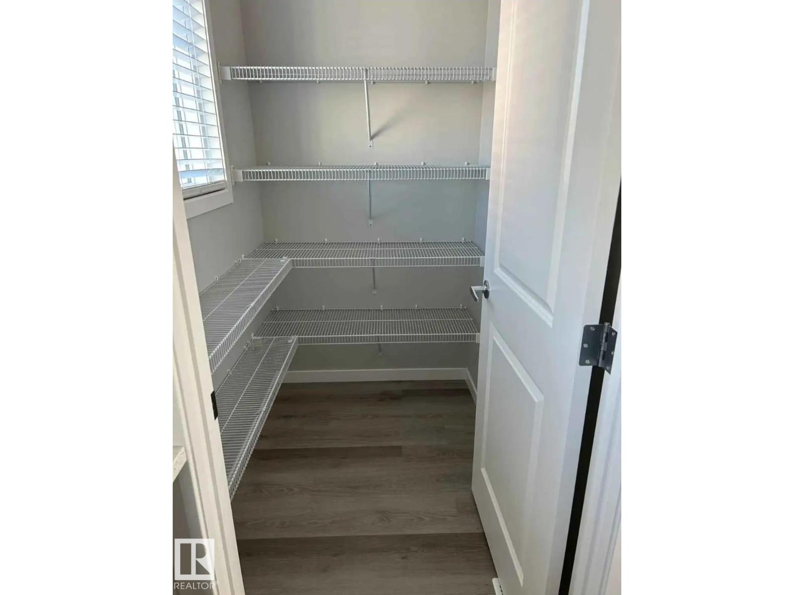 A walk-in closet with shelves and a door.
