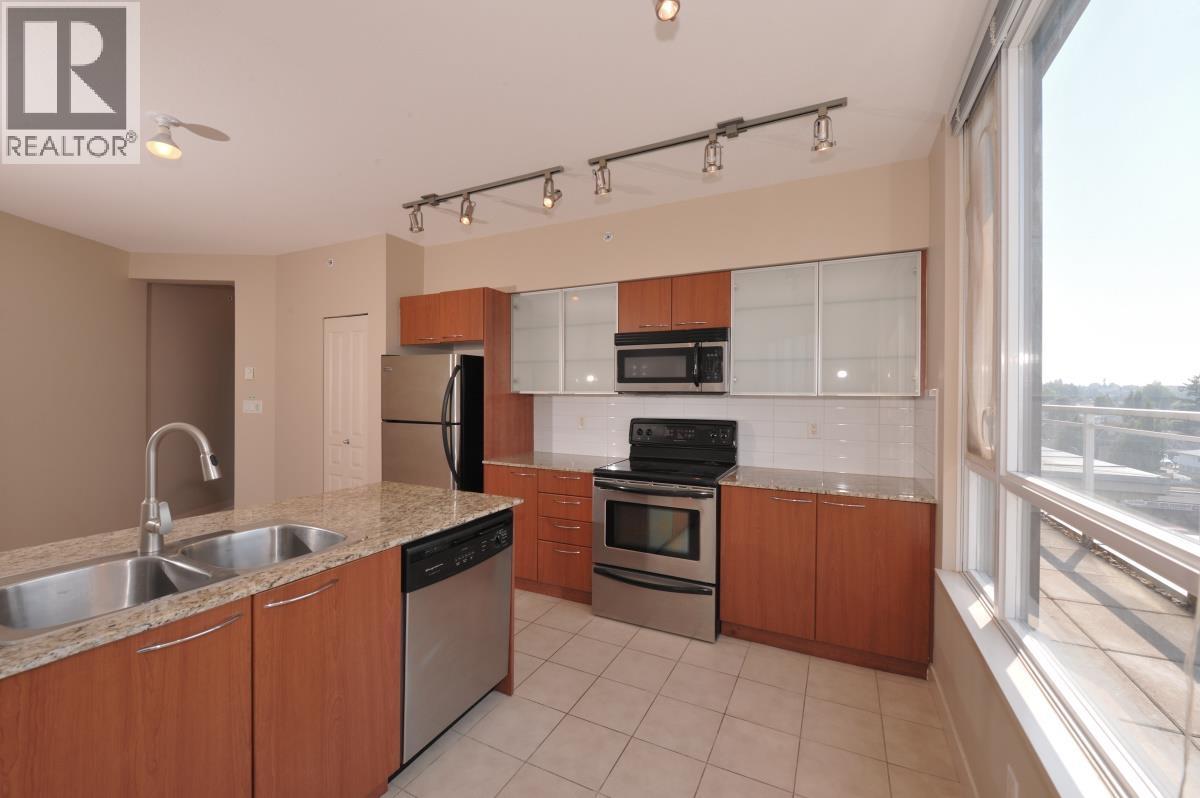 A kitchen with wooden cabinets and stainless steel appliances.