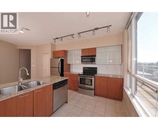 A kitchen with wooden cabinets and stainless steel appliances.
