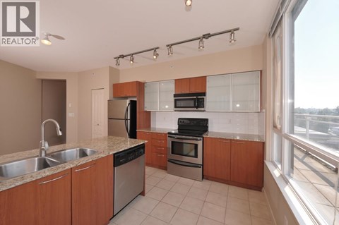 A kitchen with wooden cabinets and stainless steel appliances.