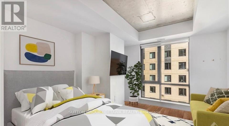 A bedroom with a large bed and a painting on the wall.