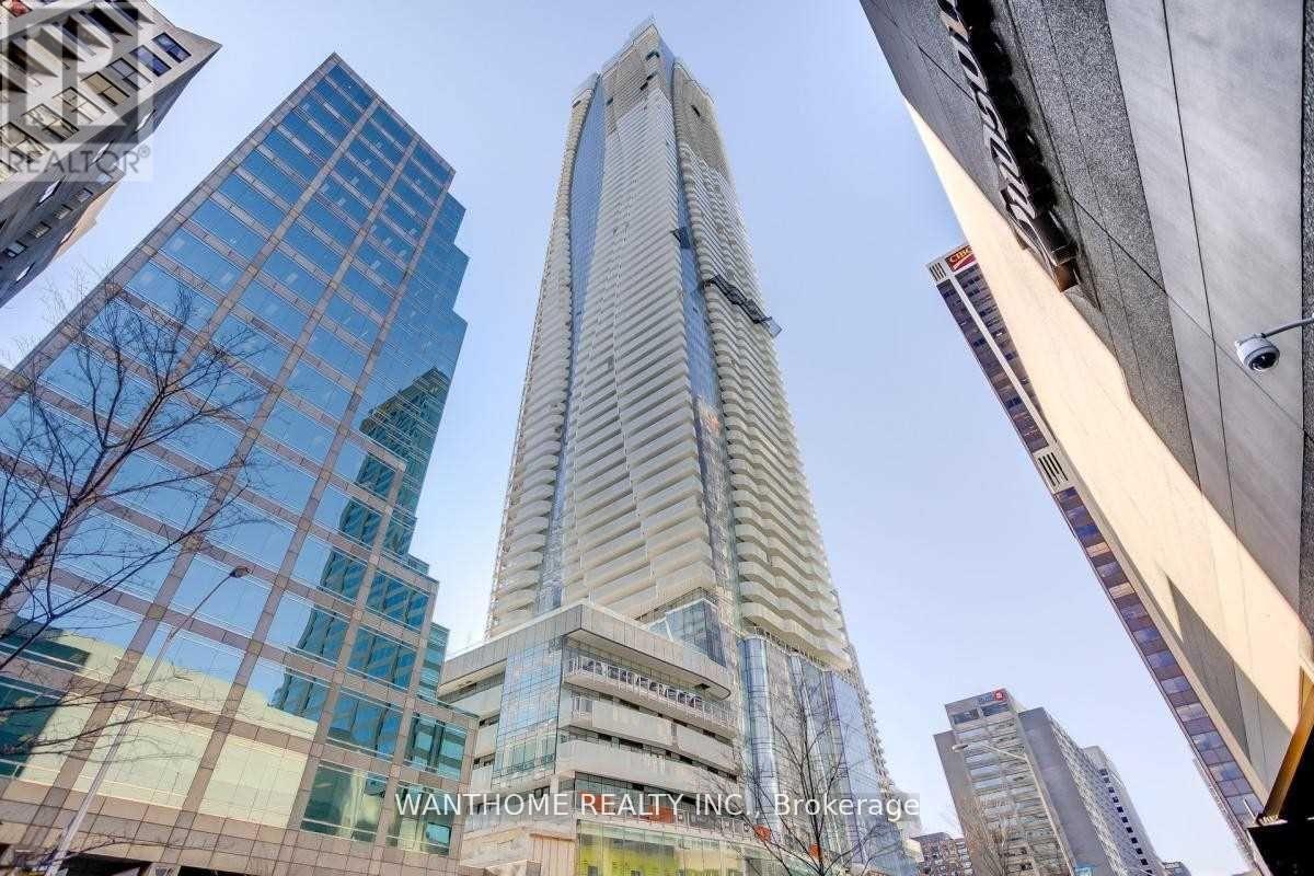 A tall building with the words "WANTHOME REALTY INC. Brokerage" on its facade stands in a cityscape.