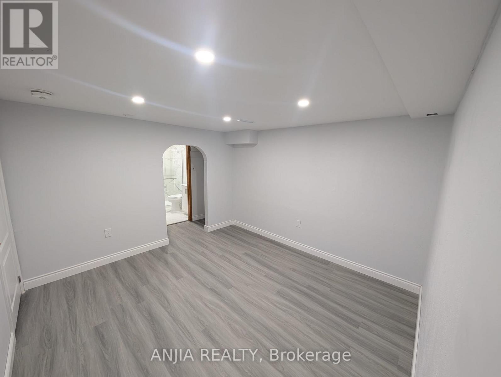 A room with a doorway leading to another room.