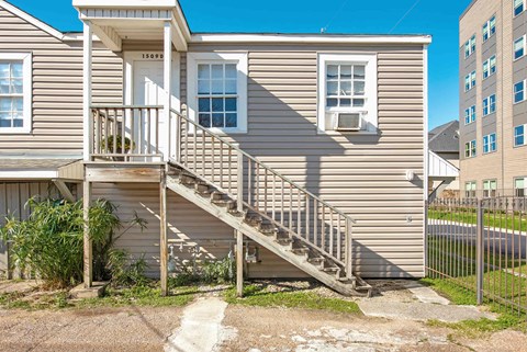 A house with a staircase leading to the front door.