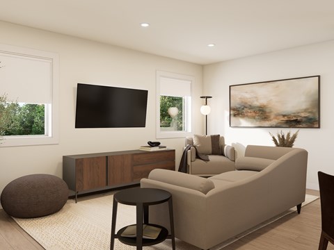 A modern living room with a large couch, a TV, and a painting on the wall.