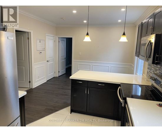 A kitchen with black cabinets and a white counter top.