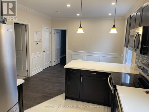 A kitchen with black cabinets and a white counter top.
