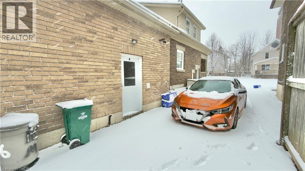 A car is parked in front of a building with a REALTOR sign on it.