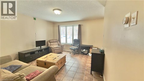 A living room with a brown couch and a wooden coffee table.