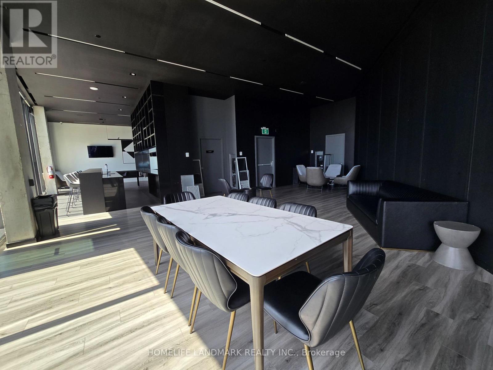 A modern dining room with a large table and chairs.