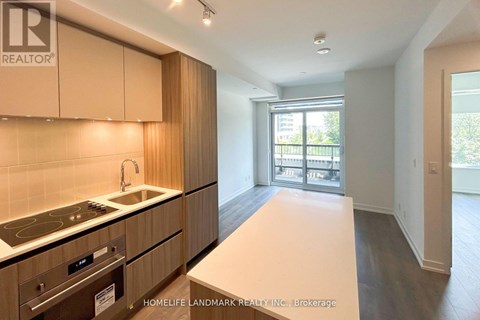 A kitchen with wooden cabinets and a stove top oven.
