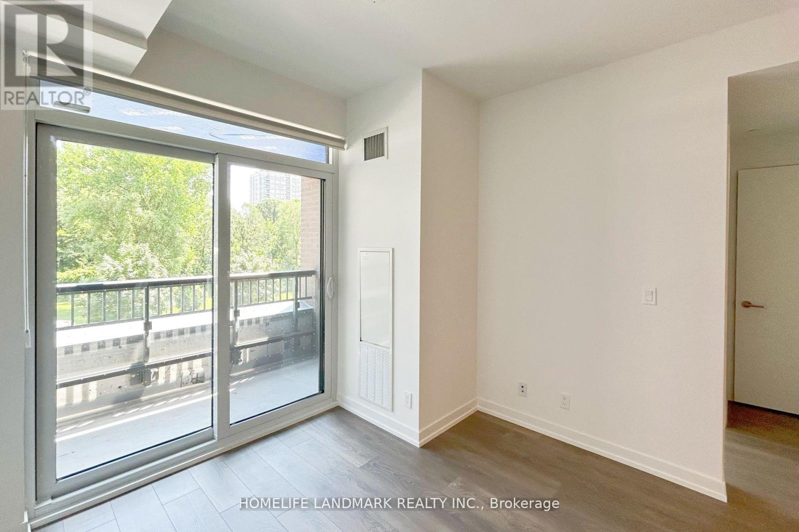 A room with a sliding glass door leading to a balcony.