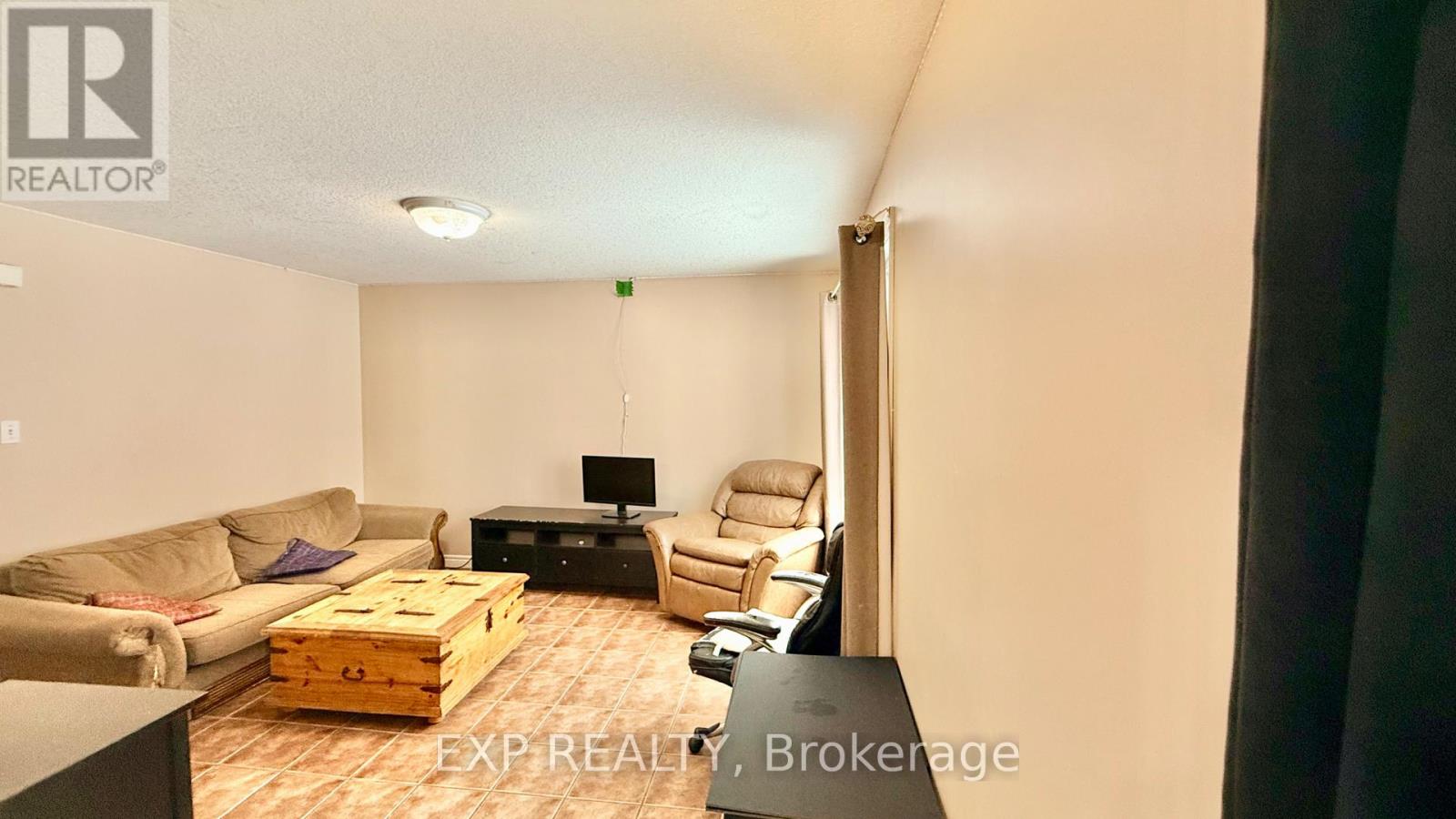 A living room with a couch, chair, and coffee table.